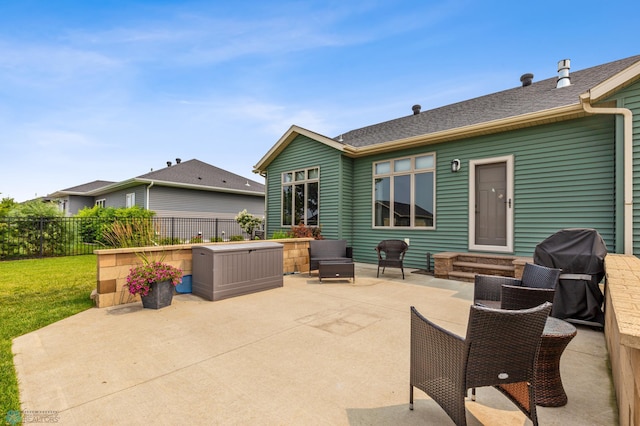 view of patio / terrace featuring a grill and a hot tub