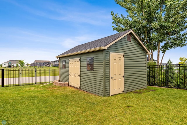 view of outbuilding with a yard