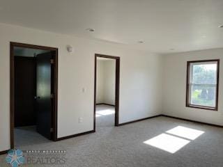 empty room featuring light carpet