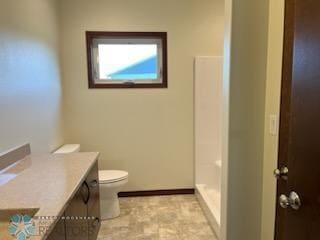 bathroom featuring tile patterned flooring, toilet, and vanity