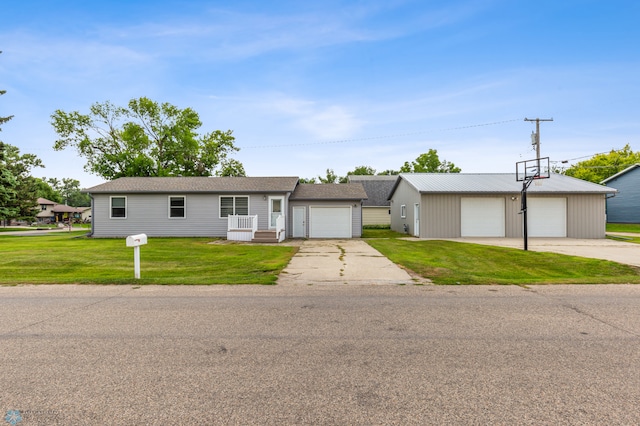 single story home with an outdoor structure, a garage, and a front yard