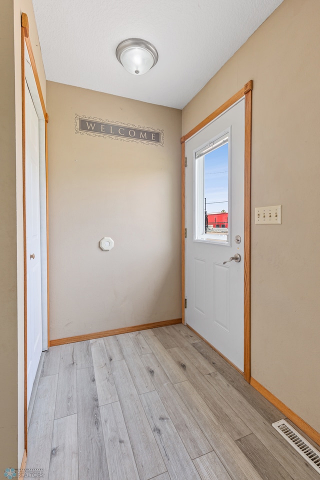 doorway with light hardwood / wood-style flooring