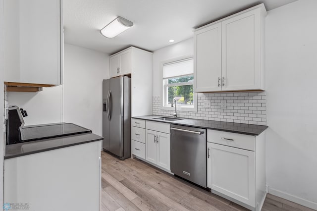 kitchen featuring white cabinetry, stainless steel appliances, and backsplash