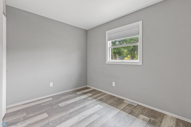 unfurnished room featuring hardwood / wood-style flooring