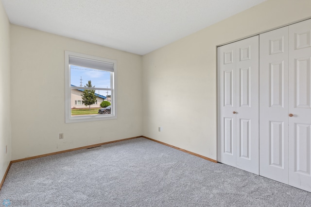 unfurnished bedroom with carpet and a closet