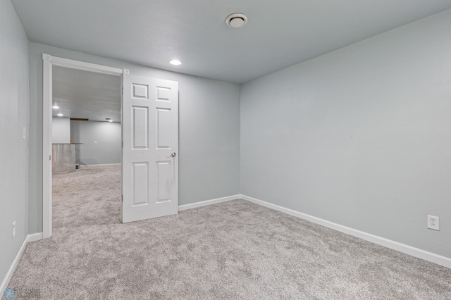 empty room featuring light carpet