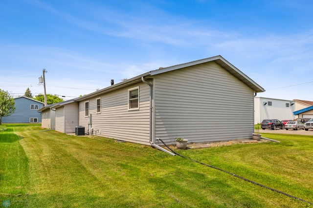 view of home's exterior featuring central AC and a lawn