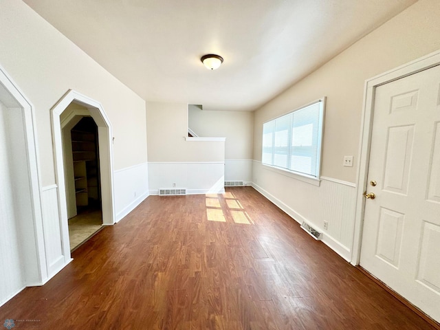 unfurnished living room featuring dark hardwood / wood-style floors