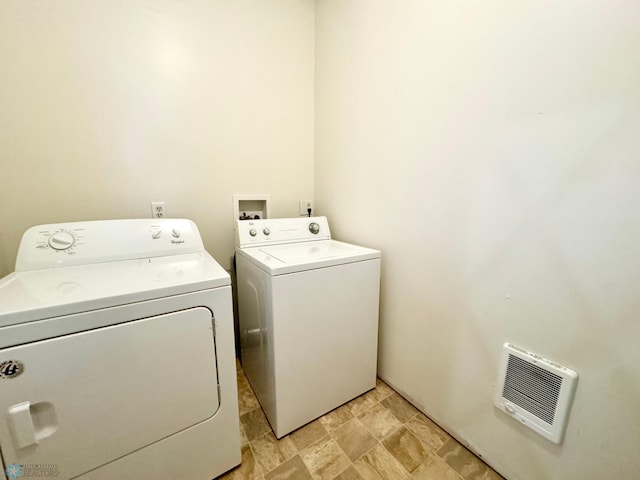 laundry room with light tile patterned flooring, washer and clothes dryer, and heating unit