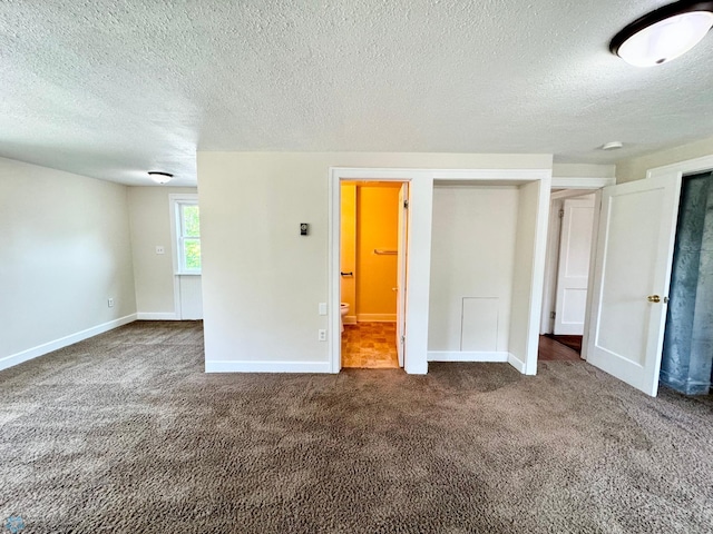 unfurnished bedroom with carpet floors and a textured ceiling