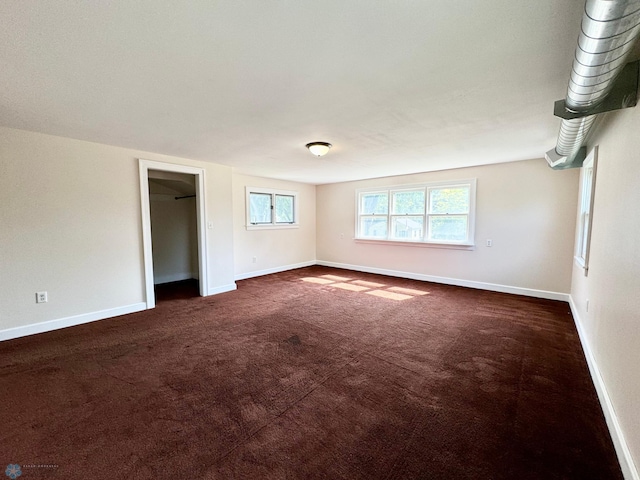 empty room with dark colored carpet