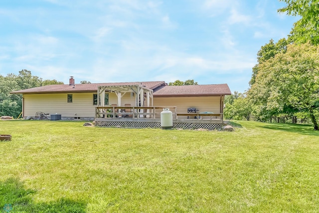 back of property with a yard, a deck, and central air condition unit