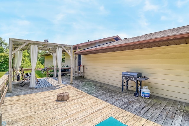 wooden terrace featuring a grill