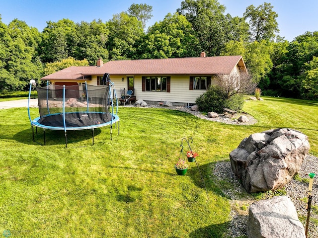 view of front of home featuring a front yard and a trampoline