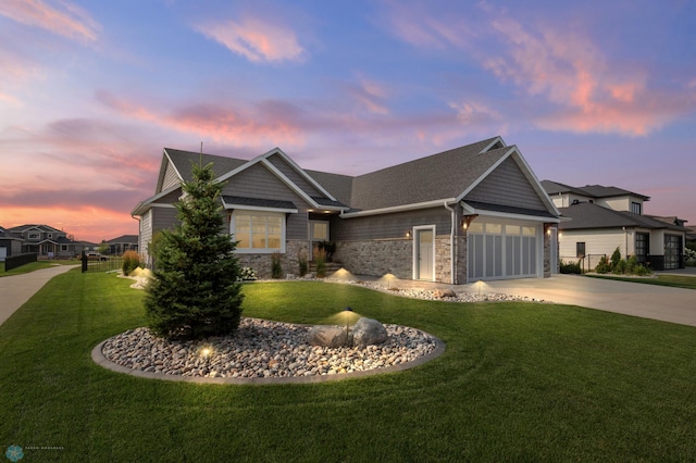 craftsman inspired home featuring a garage and a yard