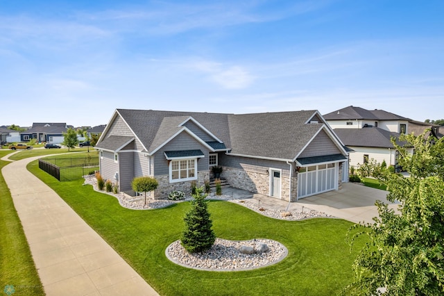 craftsman-style home featuring a garage and a front lawn