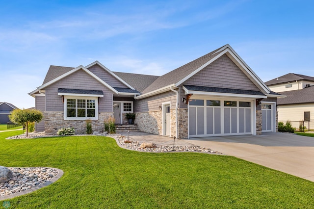 craftsman-style house with a garage and a front lawn