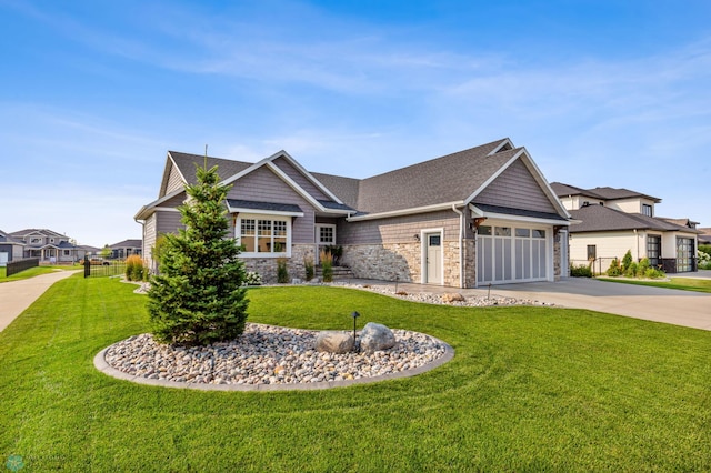 craftsman-style home featuring a garage and a front lawn