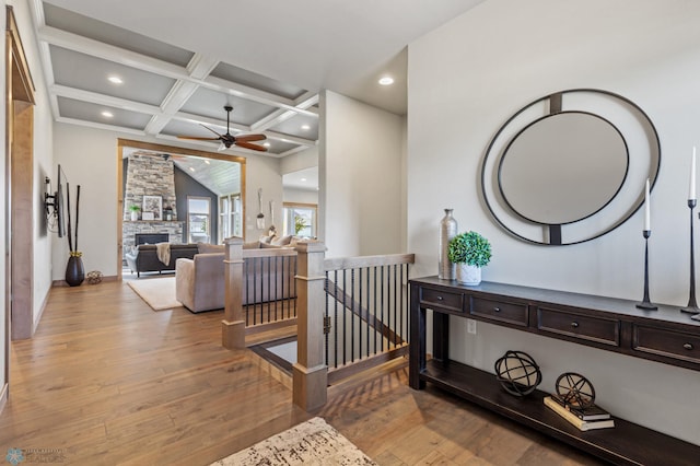 hallway with beam ceiling, wood-type flooring, and coffered ceiling