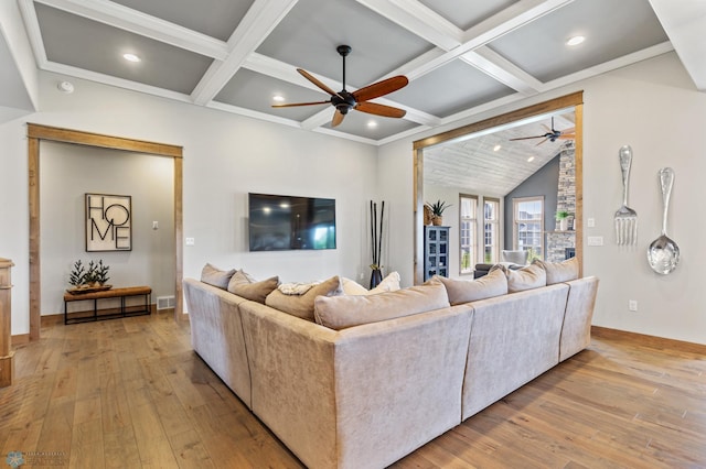 living room featuring beamed ceiling, coffered ceiling, ceiling fan, and light wood-type flooring