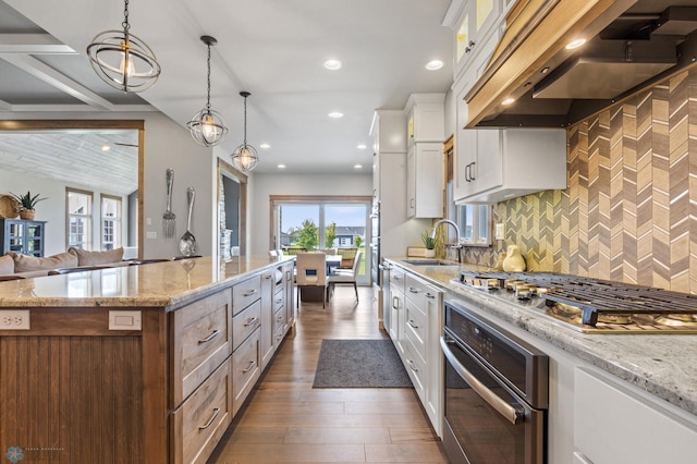 kitchen with white cabinetry, extractor fan, decorative backsplash, oven, and dark wood-type flooring