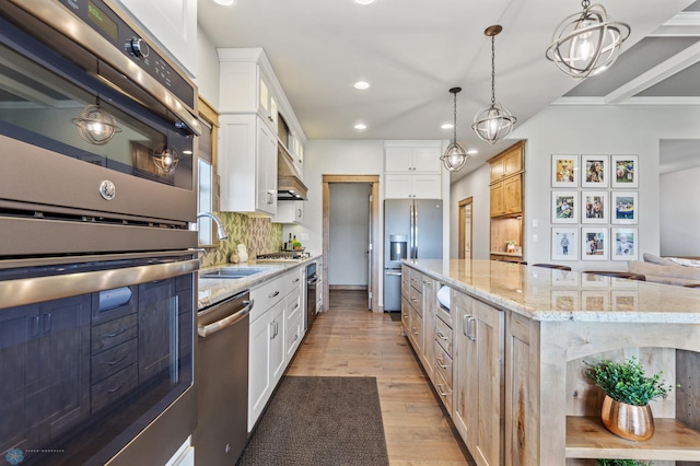 kitchen with light hardwood / wood-style floors, white cabinetry, and stainless steel appliances