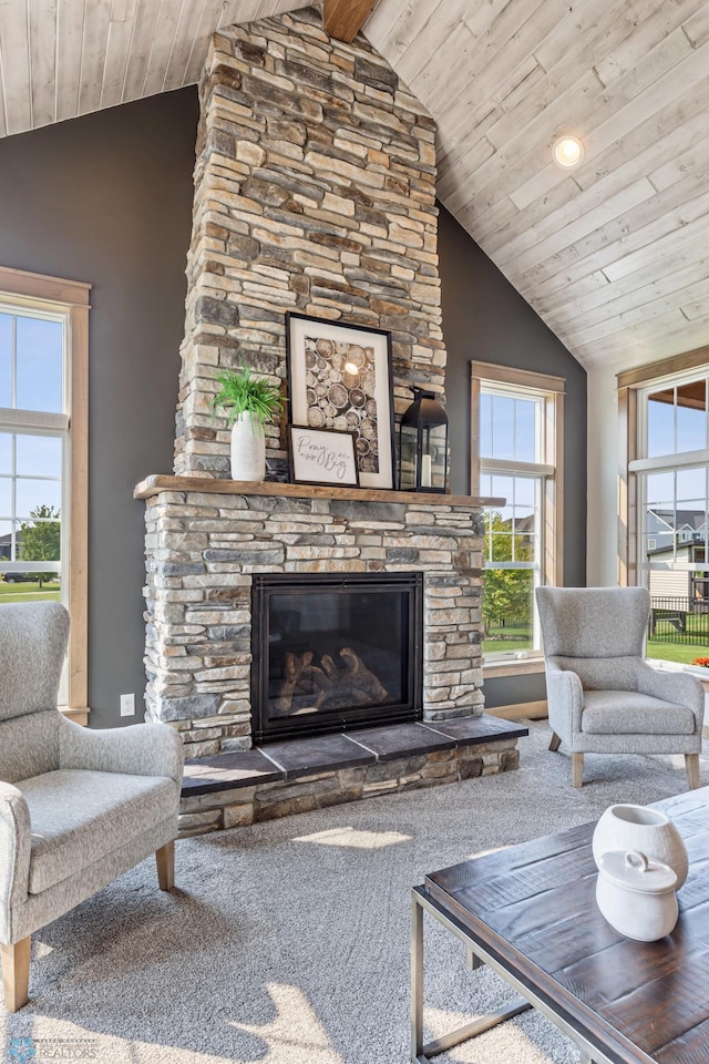 living room featuring carpet, wooden ceiling, a stone fireplace, and lofted ceiling