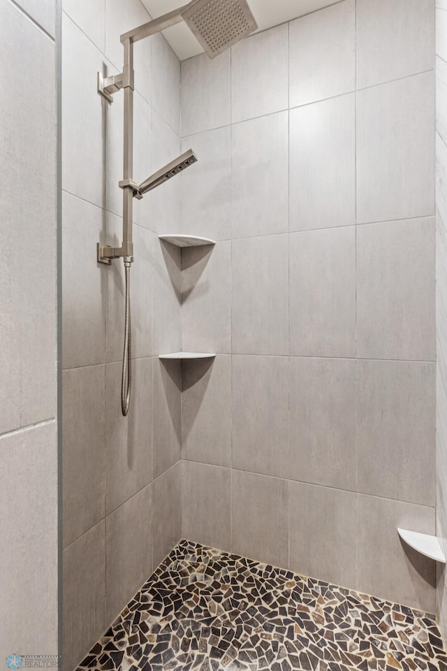 bathroom with a tile shower