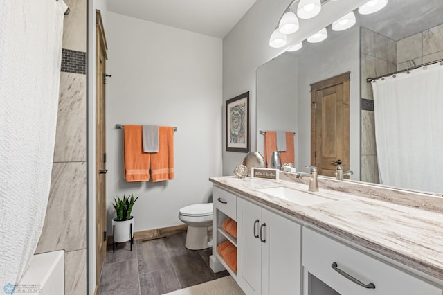 bathroom with hardwood / wood-style flooring, toilet, and vanity