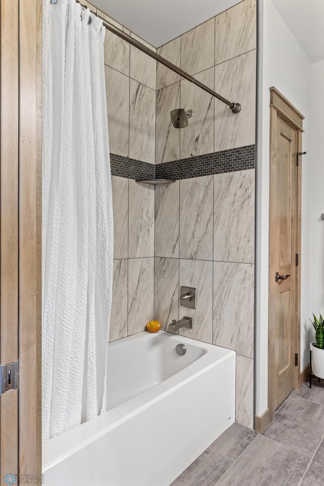 bathroom featuring shower / bath combo, tile walls, and tile patterned floors