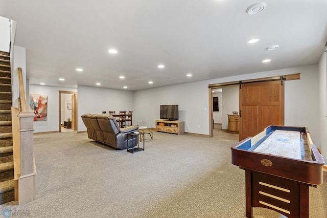 playroom featuring light carpet and a barn door