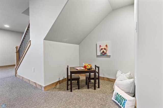 dining space with light carpet and lofted ceiling