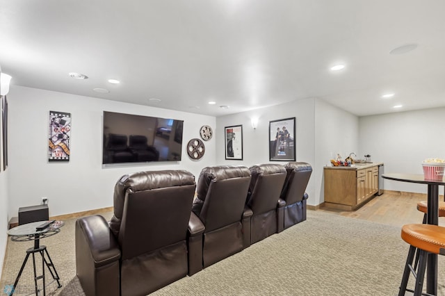 cinema room featuring sink and light hardwood / wood-style flooring