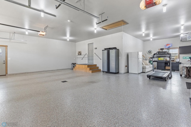 garage featuring a garage door opener, fridge, and white refrigerator