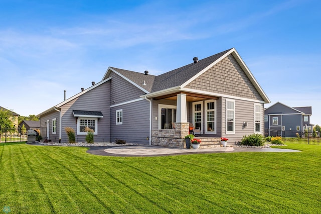 rear view of house featuring a patio and a lawn