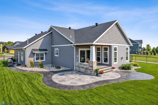 back of property featuring a patio and a lawn