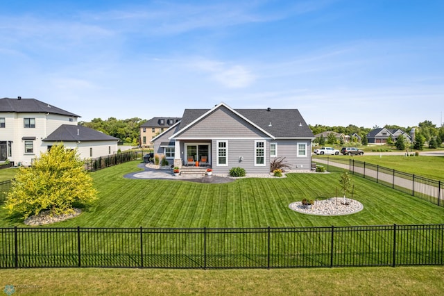 rear view of property with a patio area and a yard