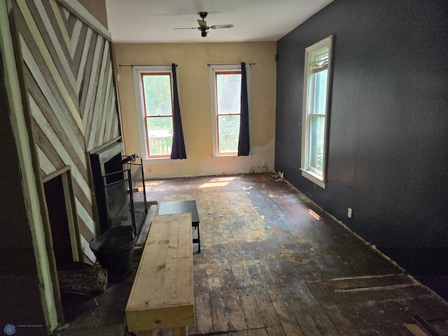 unfurnished living room featuring hardwood / wood-style flooring, a healthy amount of sunlight, and ceiling fan