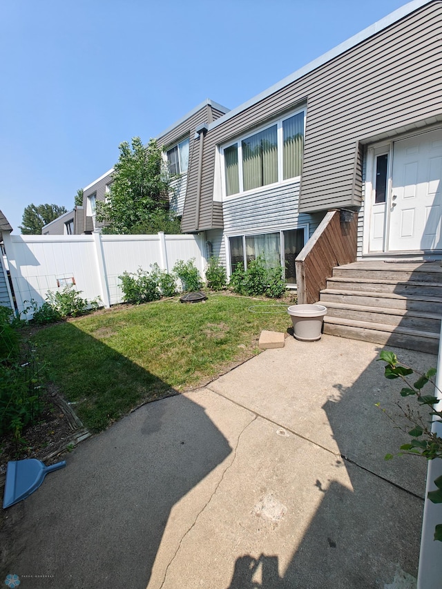 back of house featuring a patio and a lawn