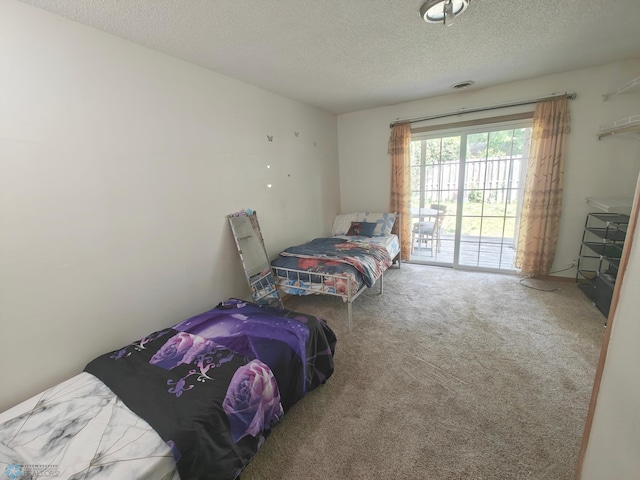 bedroom featuring carpet flooring and a textured ceiling