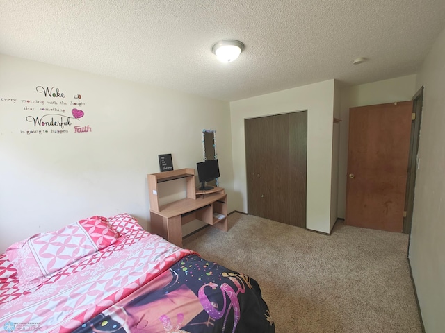 bedroom with carpet floors, a textured ceiling, and a closet