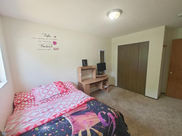 carpeted bedroom featuring a closet and a textured ceiling