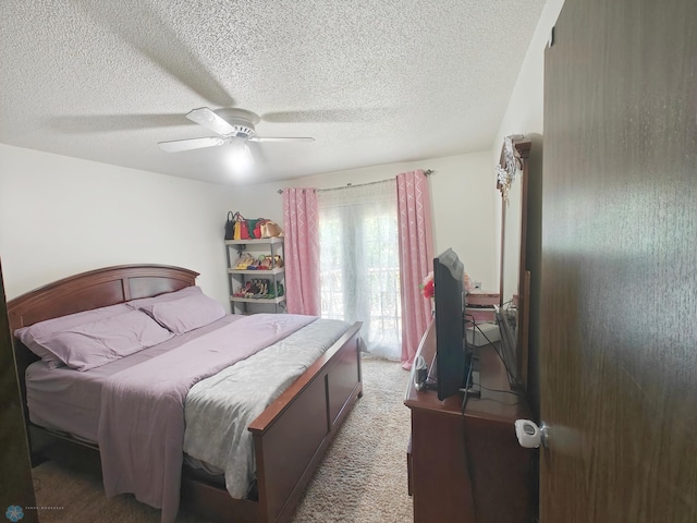 carpeted bedroom featuring a textured ceiling and ceiling fan