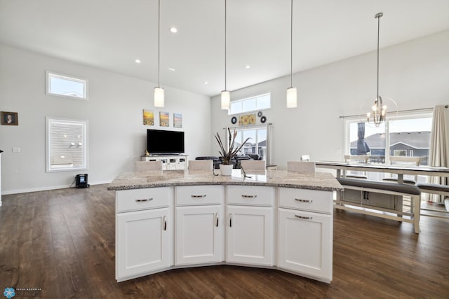 kitchen with dark hardwood / wood-style flooring, white cabinets, and light stone countertops