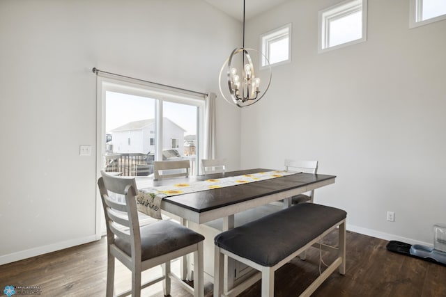 dining room featuring a notable chandelier, dark hardwood / wood-style floors, and a high ceiling