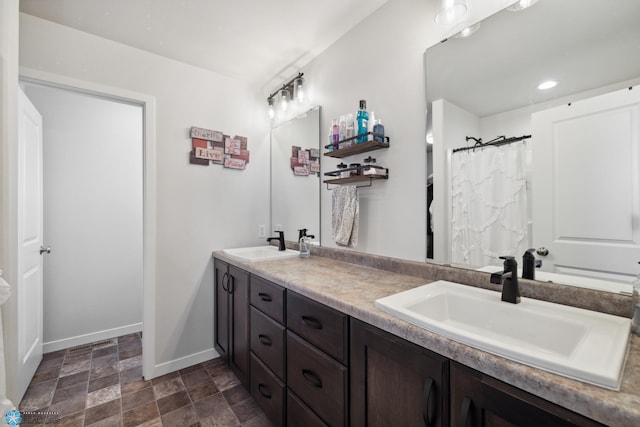 bathroom with tile patterned flooring and dual bowl vanity