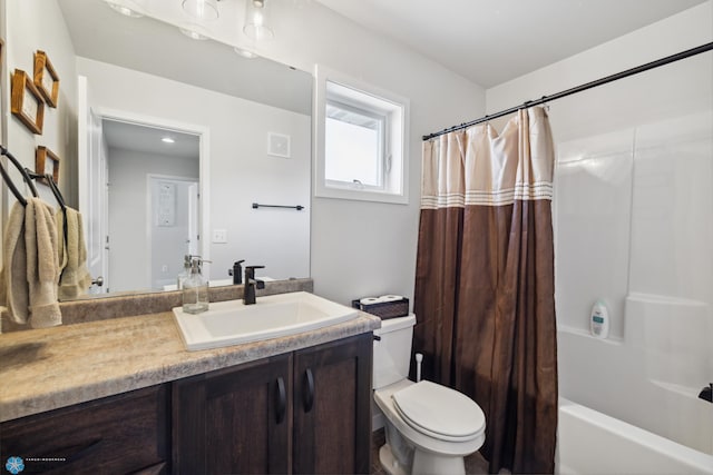 full bathroom featuring shower / bath combo, toilet, and vanity