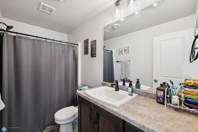 bathroom with vanity, tile patterned flooring, and toilet