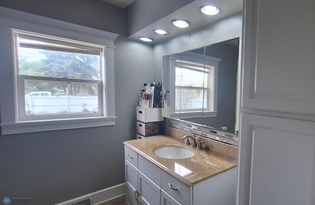 bathroom with vanity and a healthy amount of sunlight