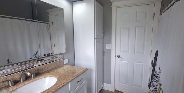 bathroom with vanity and backsplash